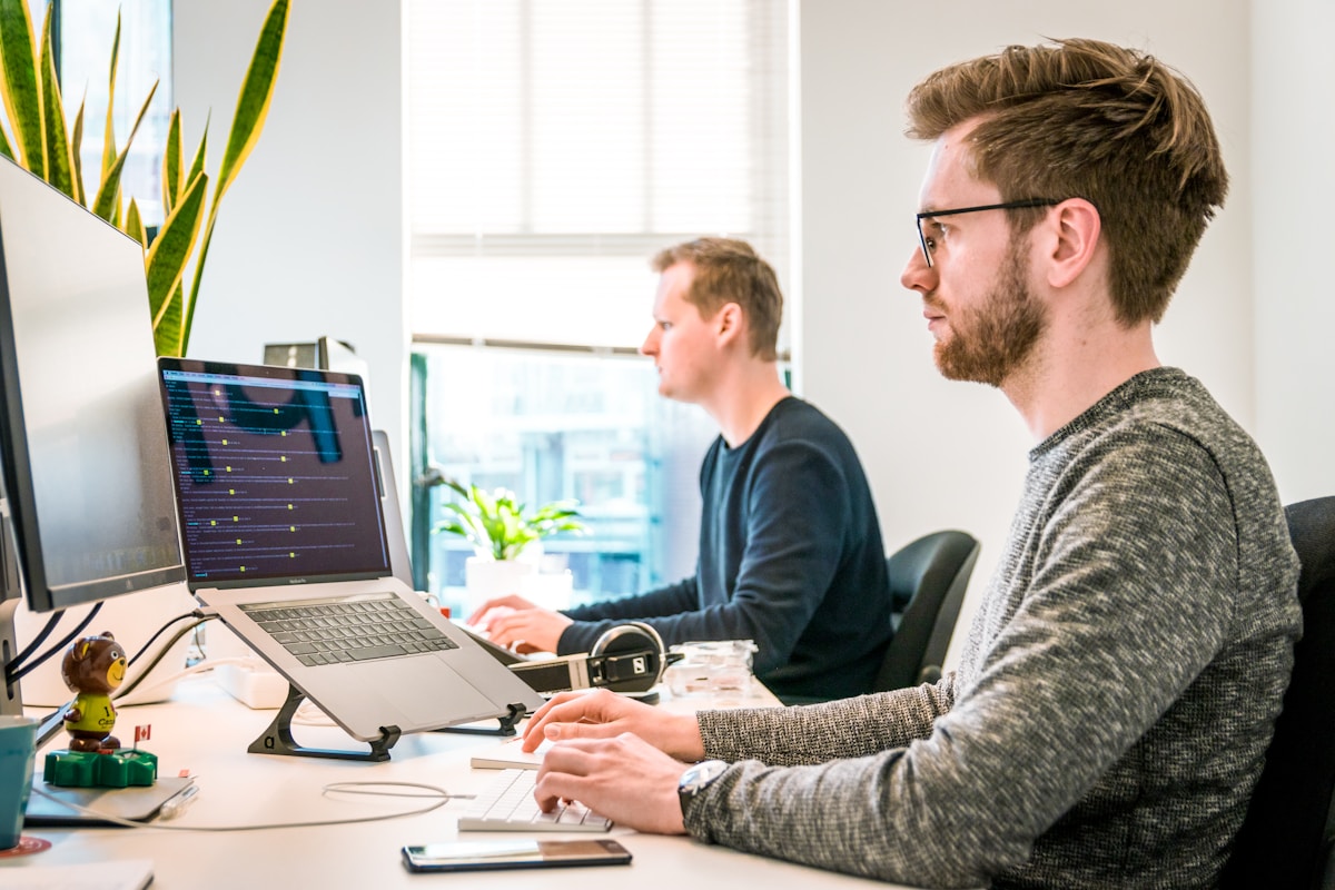 Developers collaborating at workstations